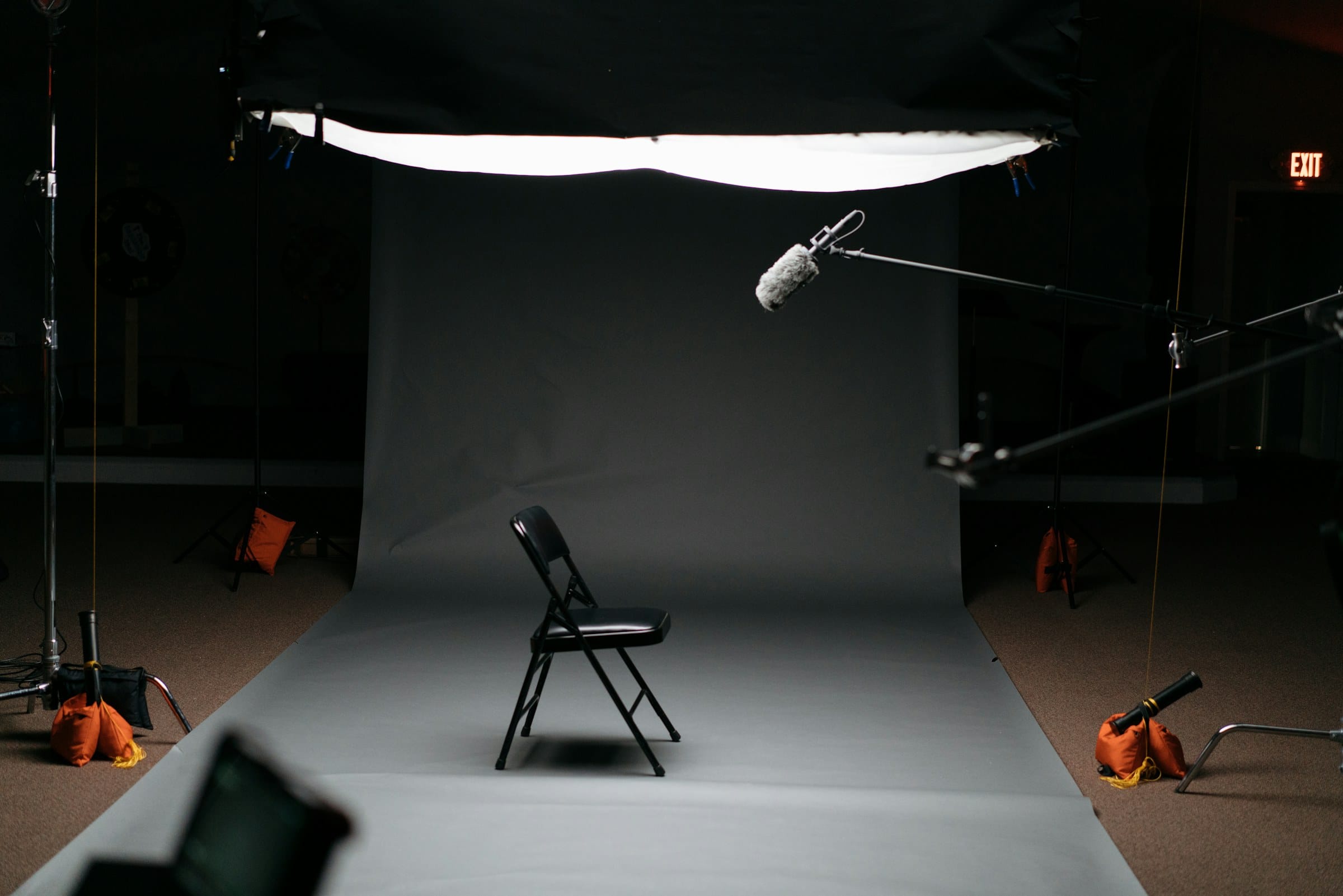 Empty studio set with a chair under a softbox